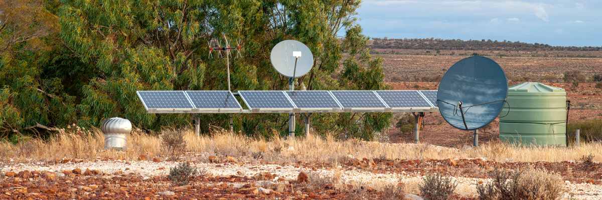 Image of desert land with satellite and solar panels 