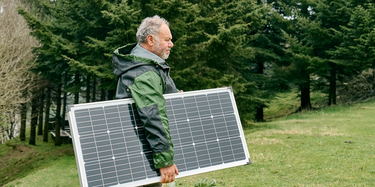 Man carrying solar panel 