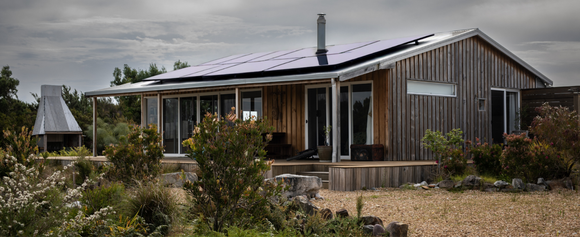 Wood-sided off-grid cabin with solar panels