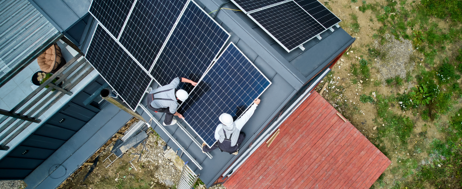 People installing solar panels on roof