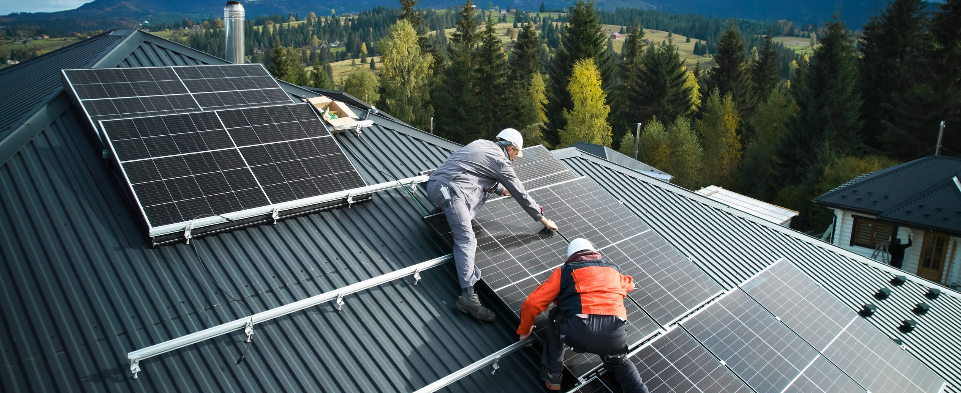 People installing solar panels on metal roof