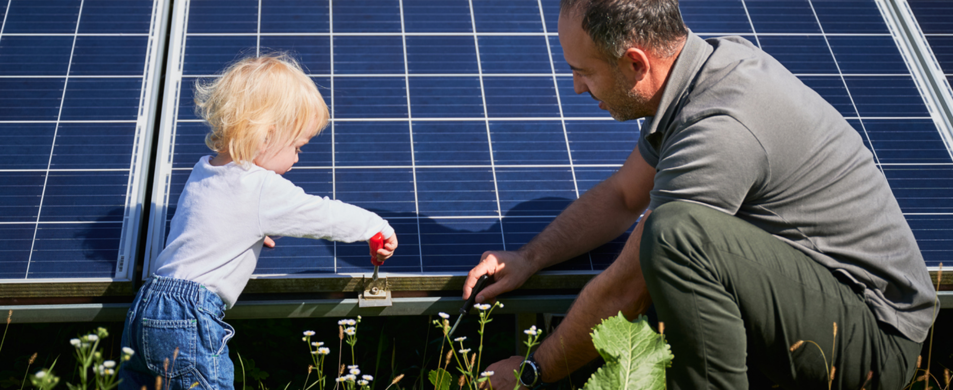 Dad and daughter looking at solar panels