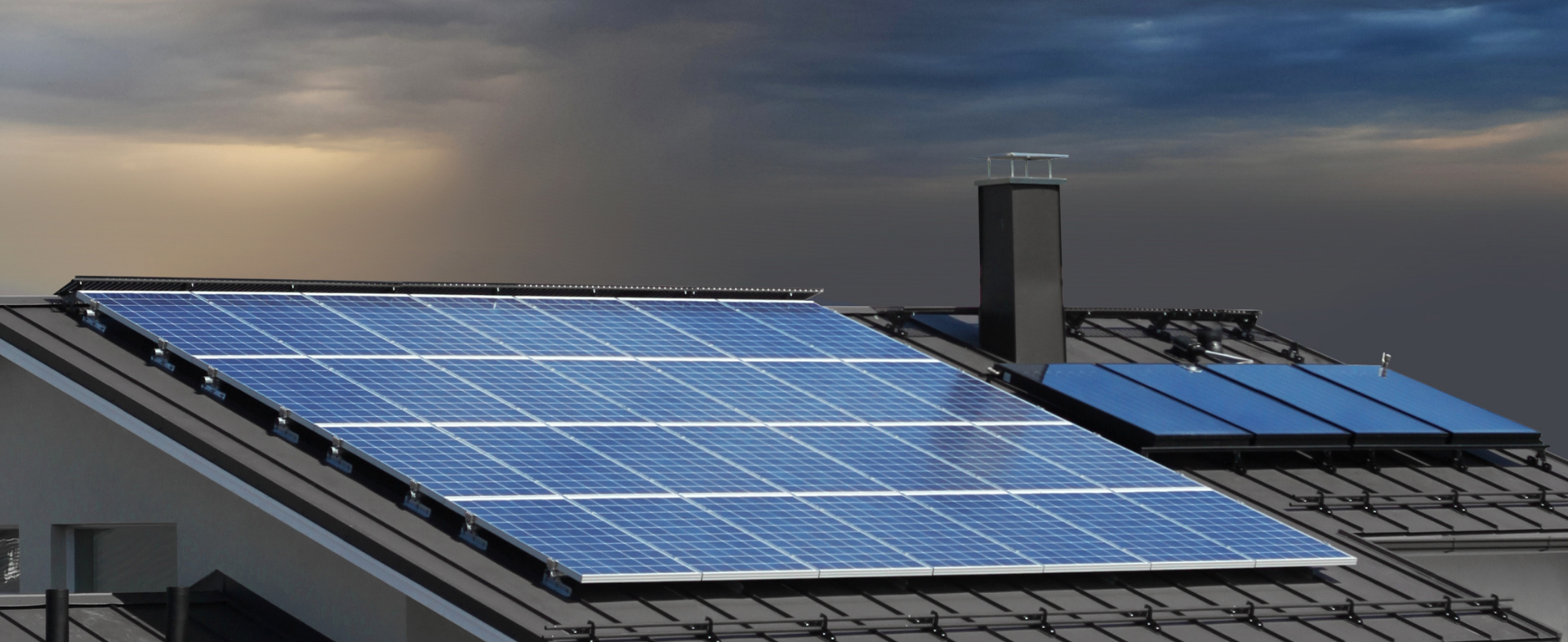Roof with solar panels and dark cloudy storm above
