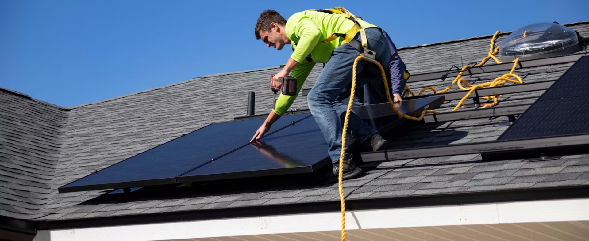 Man on roof installing solar panels