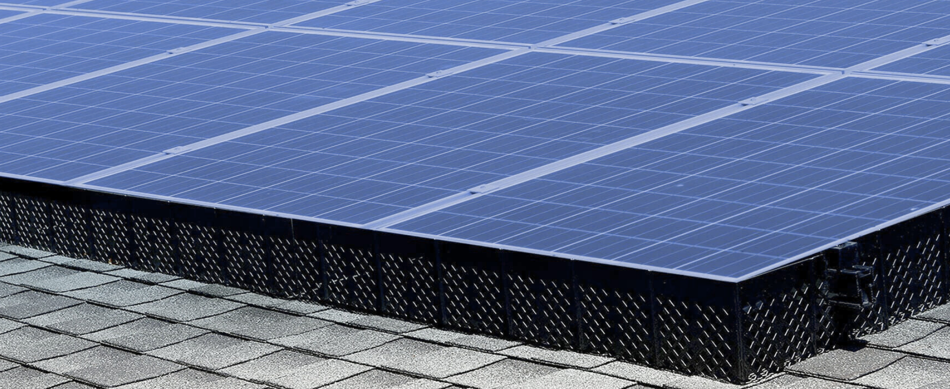 SolaTrim pest abatement system installed on roof under solar panels.