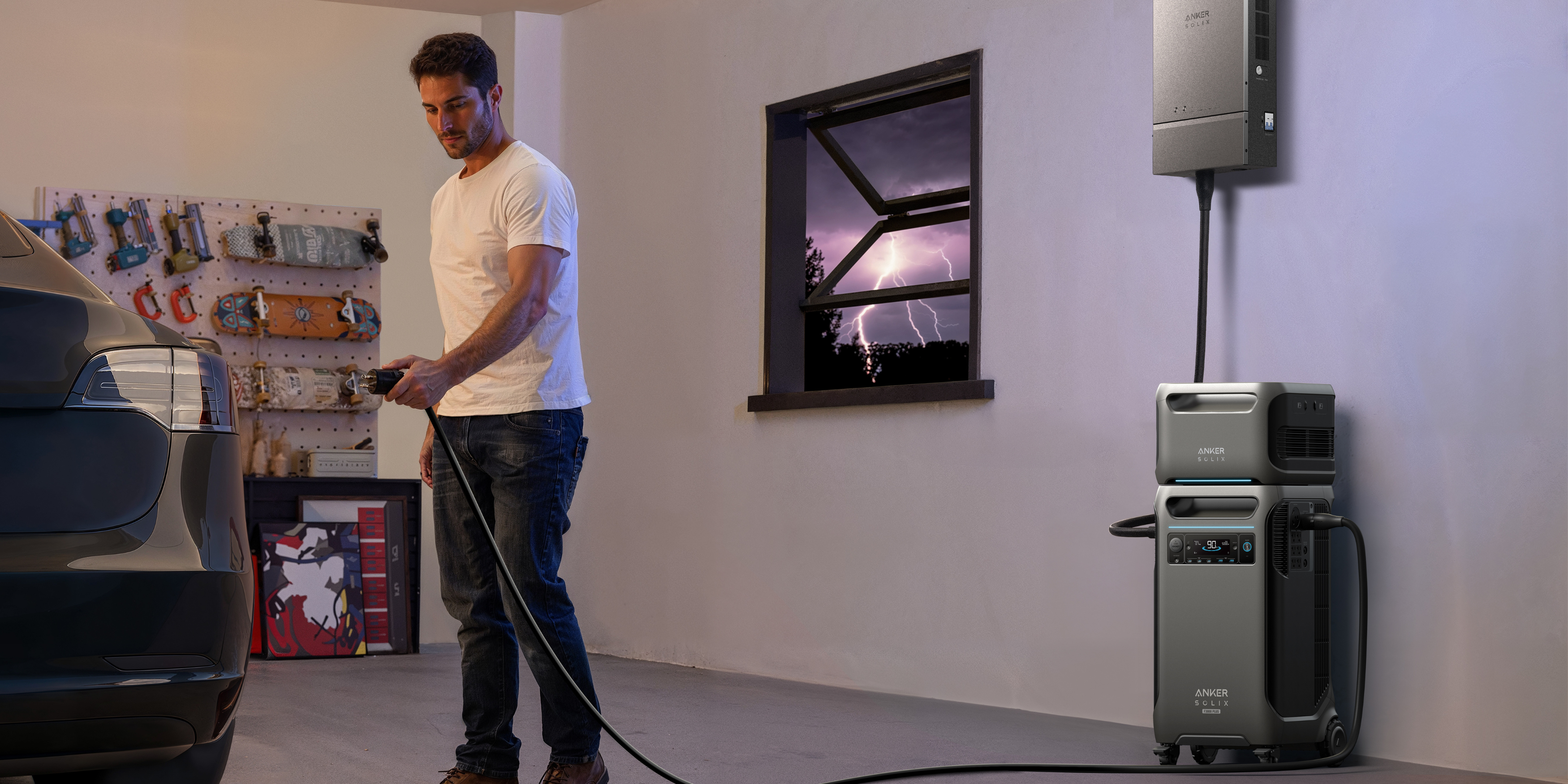 Man charging electric vehicle with Anker power system in garage on stormy night.